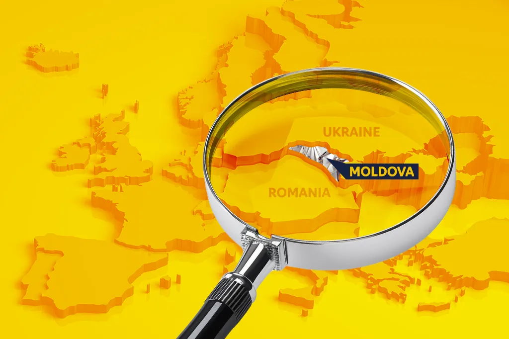 A magnifying glass over a yellow relief map of Europe highlights Moldova between Romania and Ukraine.