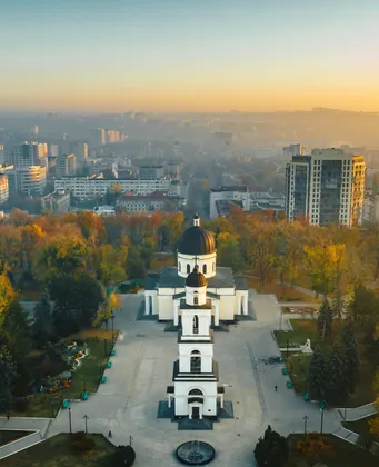 Aerial view of Chișinău at sunrise with the white cathedral and park in autumn colours
